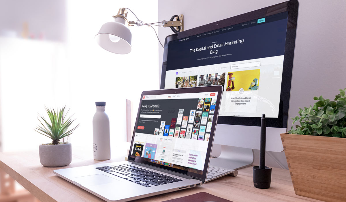 Laptop and desktop computer screens on a stylish desk, displaying email marketing resources.