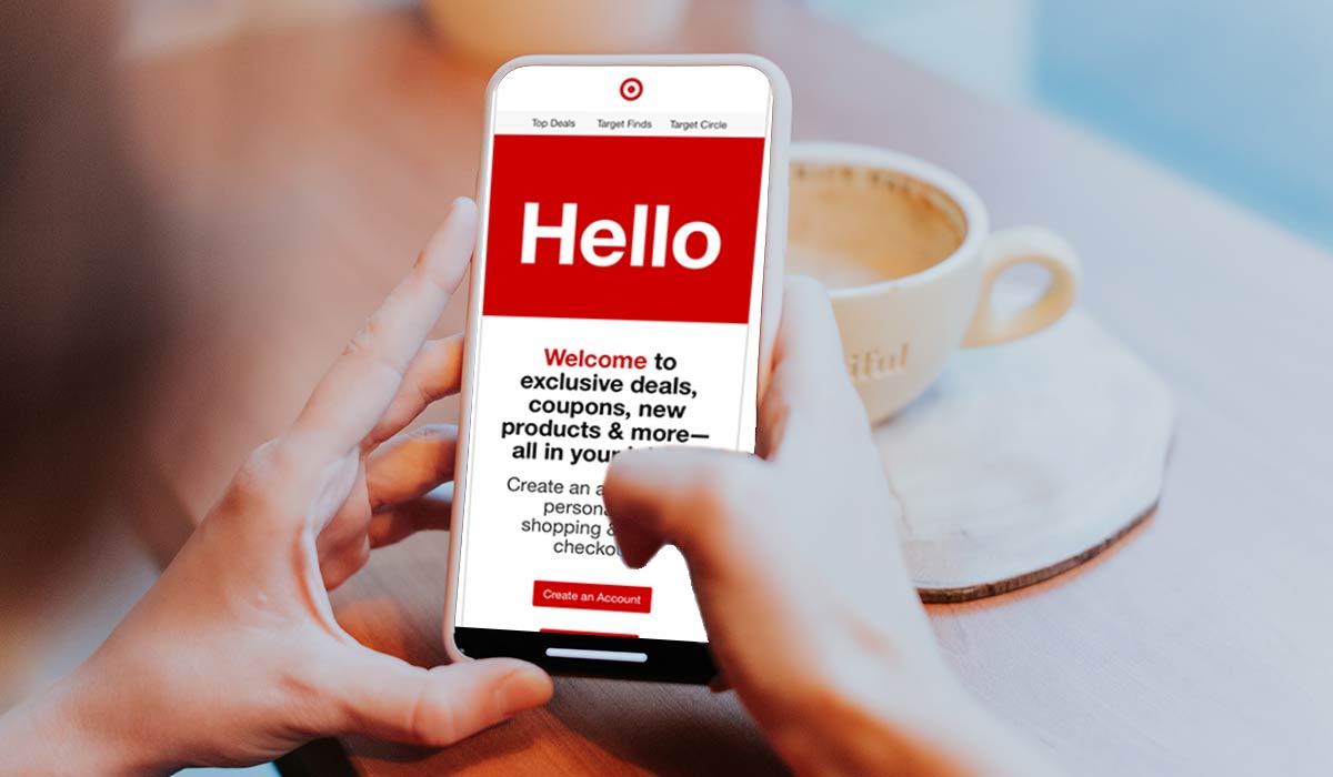 Customer reading a welcome email on a phone in a cafe.