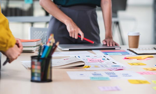 Creative team maps out strategy with colorful paper.