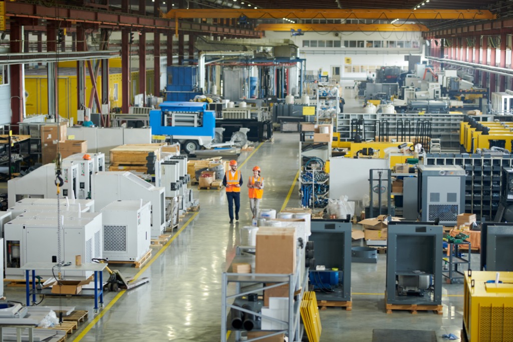 Two engineers walking through a factory