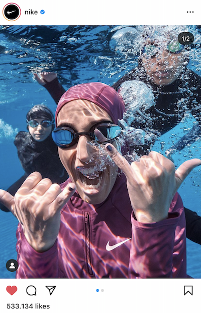 Nike Instagram post featuring an underwater closeup of a woman wearing goggles and a pink hijab swimsuit.